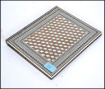 An Anglo-Indian ivory and sandalwood blotter, inlaid with bands of sadeli, with a plush and silk