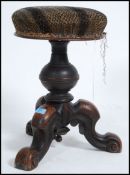 A Victorian revolving walnut piano stool, with over stuffed seat pad. Measures 50cm high x 42cm wide