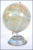 A retro 20th century rotating globe ' The Planet Geographia ' of Fleet Street. Raised on a