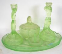 An Art Deco Lalique inspired green pressed glass Dressing Table Set consisting of tray, two