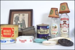 A collection of vintage and retro 20th century advertising pieces to include ashtray's, biscuit