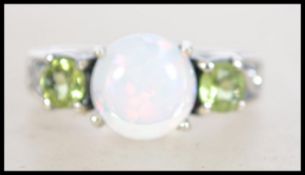 A ladies 20th century silver peridot and opal thre