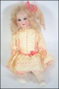 A 19th century original small Armand Marseille doll no.390 complete with wig and silk embroidered
