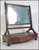 A 19th century Georgian  mahogany toilet swing mirror. The plinth base with central trinket drawer
