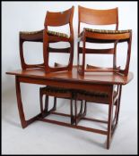 A 1970's Danish inspired teak dining table and 4 chairs - suite. The chairs with angular frames