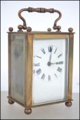 An early 20th century brass cased carriage clock having inset movement with carved lion motif. The