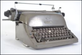 A vintage industrial 20th century typewriter by Adler having original grey finish.