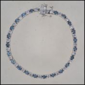A ladies decorative silver 925 tennis bracelet adorned with 44 aquamarine coloured stones and cz'