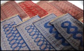 A collection of 20th century machine woven runners - rugs to include various colours and designs