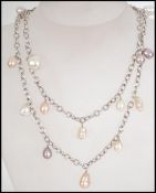 A long silver and baroque twin string pearl neckla