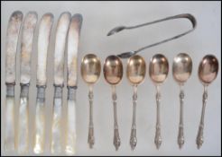 A collection of silver hallmarked collar knives with faux mother of pearl handles. Hallmarked for JS