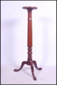 A Victorian solid mahogany torchere / plant stand raised on splayed legs base with turned thick