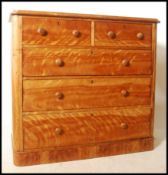 A Victorian satin birch 2 over 3 chest of drawers being raised on a plinth base with 2 short over