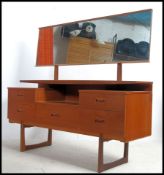 A good 1970's Danish inspired teak wood dressing table being raised on tapering supports having a