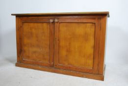 A late 19th / early 20th century pine wood school cupboard. With twin full length doors opening to