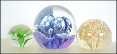 A collection of 3 20th century glass paperweights
