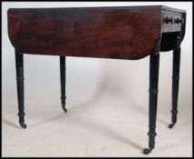 A Victorian mahogany pembroke table raised on turn