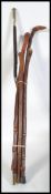 A collection of five 20th century tall walking sticks made from various woods please see images.