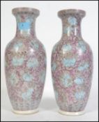 A pair of Chinese republic ceramic vases of famille rose design having purple and blue flower and