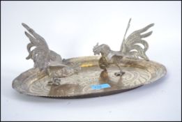 A pair of silver platted fighting cocks in different stances together with an early 20th century