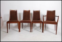 A set of four retro G Plan teak wood dining chairs having a brown velour seat pad and backrest.