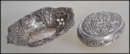An eastern silver snuff box having squeeze side opening. Chased with flowers etc of lozenge form.