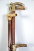 Three antique antler mounted hunting sticks and a