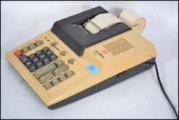 A vintage 1970's Olympia desk top calculator complete with till roll and digital display