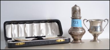A group of silver hallmarked items to include a silver hallmarked sugar sifter having pierced top