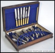 An early 20th century canteen of cutlery by Viners set in baize lined box with sectional interior.