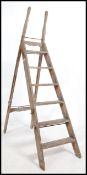 A good 19th century Industrial step ladder with shaped cast iron bracket work to the extending a-