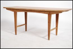 A retro 20th century teak wood coffee table by Vanson raised on angular supports united by