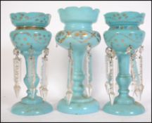 A collection of 3 19th century Victorian blue glass table lustres, each with gilded decoration