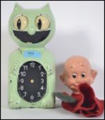 A vintage mid 20th century wall clock in the form