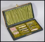 A late 19th century leather and brass cased sewing kit the hinged lid opening to reveal a