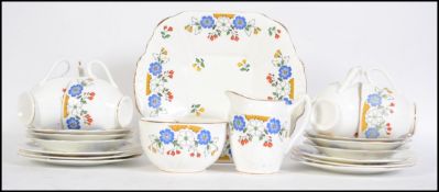 A 1930's Art Deco Staffordshire tea service in a good chintz pattern comprising cups, saucers,