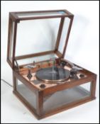 A 1930's Art Deco oak and glass cased electric gra