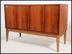A 1970's teak sideboard / entertainment cabinet having  squared legs with small proportioned body