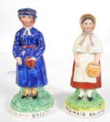 A pair of Victorian Staffordshire figures of a girl and boy, the bases inscribed Red Maid