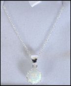 A contemporary ladies silver and opal pendant neck