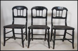 A set of 3 Victorian aesthetic movement ebonised dining chairs raised on bobbin turned supports