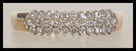 A 9ct gold and diamond ladies ring having rows of cluster diamonds approx 30-40pnts total . The