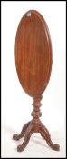 Victorian walnut loo table, oval tilt top with a moulded edge, shaped apron, turned and carved