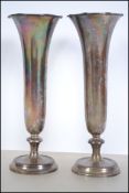 2 silver hallmarked solifleur vases with scalloped tops on tapering shafts with terraced feet.