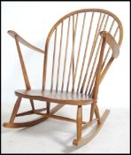 A 20th century Golden Dawn Ercol beech and elm Quaker spindle back rocking chair