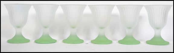 A set of six early to mid 20th century frosted glass fluted sundae dishes raised on pastel green