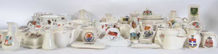 A good collection of various Goss / crested wares to include cheese dishes, wheel barrow, vases,