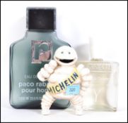 A cast metal advertising  Bibendum for Michelin character together with oversized perfume