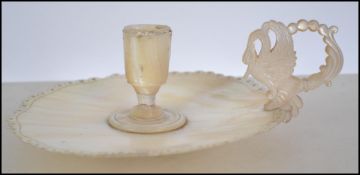 A 19th century mother of pearl shell chamberstick