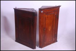 A Georgian 19th century oak inlaid corner cabinet having single door with shelved interior and 3